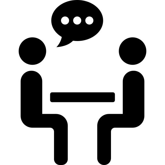 Two persons talking sharing sitting on a table