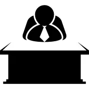 Chief sitting behind a desktop