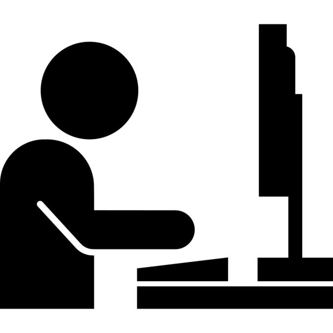 Man working on flat monitor on side view