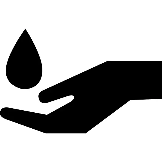 Water drop falling on a hand