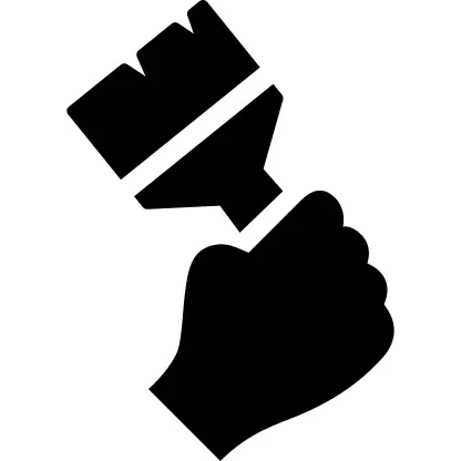 Hand holding up a paintbrush