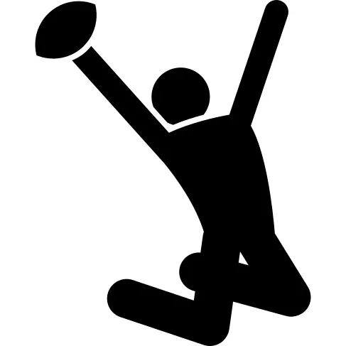 Rugby player celebrating with the ball