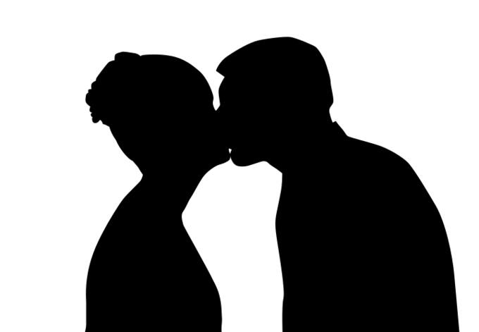 Silhouette of young couple kissing vector drawing
