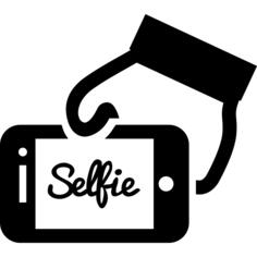 Selfie word on phone screen in a hand