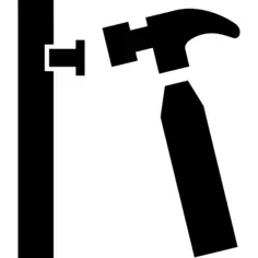 Hammer nailing a nail in a wall