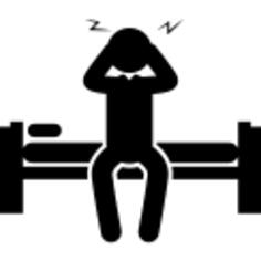 Sleepy man sitting on his bed